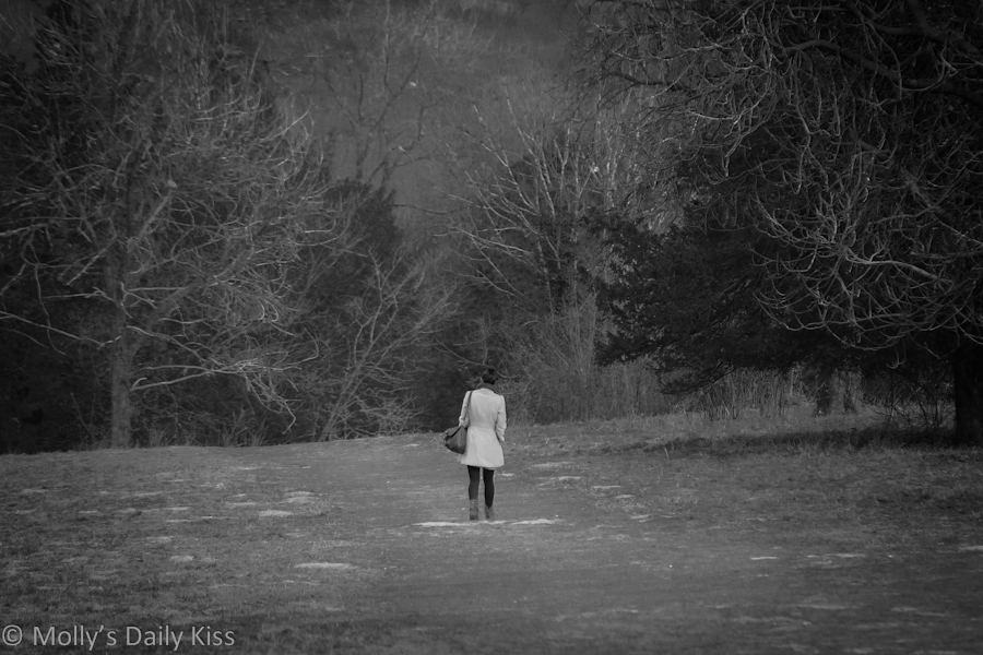 woman walking in countryside alone. Promise